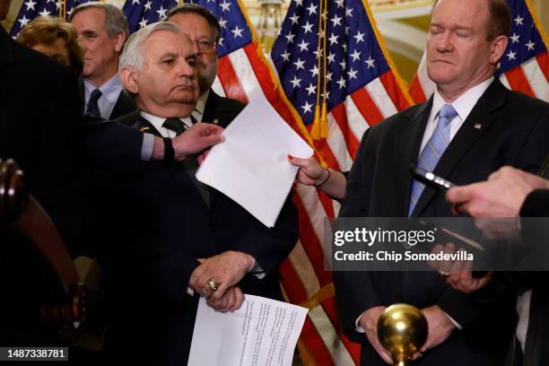 Sen. Jack Reed leans back as paperwork is passed during a news conference where Senate Democrats proposed their proposed China competitiveness...