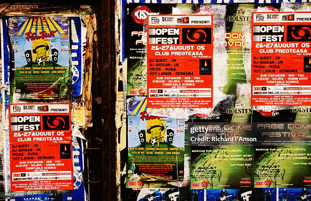 Posters on street wall.