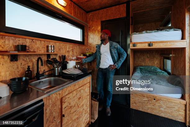 african american man in trailer. - small luxury kitchen stock pictures, royalty-free photos & images