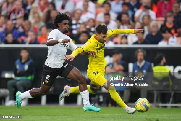 Alex Baena of Villarreal CF battles for possession with Thierry Correia of Valencia CF during the LaLiga Santander match between Valencia CF and...