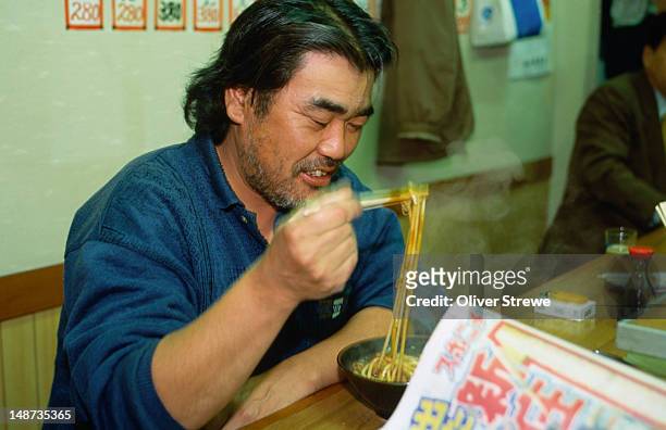 eating noodles in shin-sekai, osaka. - osaka shinsekai food stock-fotos und bilder