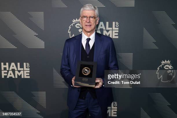 Arsene Wenger poses for a photograph with their medallion during a Premier League Hall of Fame event on May 03, 2023 in London, England.