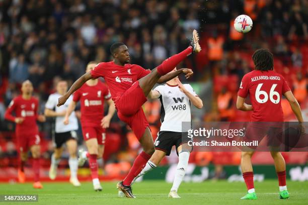 Ibrahima Konate of Liverpool controls the ball whilst under pressure from Tom Cairney of Fulham during the Premier League match between Liverpool FC...
