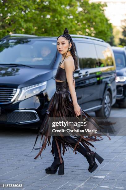 Marzhan Sharipova wears black fringes skirt, top, brown bag at VISA Fashion Week Almaty Season VII on May 03, 2023 in Almaty, Kazakhstan.