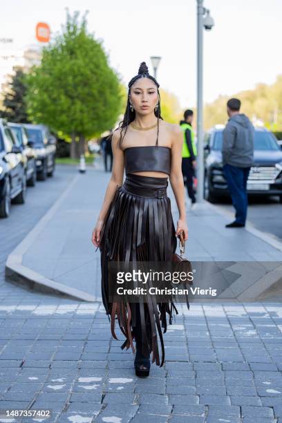 Marzhan Sharipova wears black fringes skirt, top, brown bag at VISA Fashion Week Almaty Season VII on May 03, 2023 in Almaty, Kazakhstan.