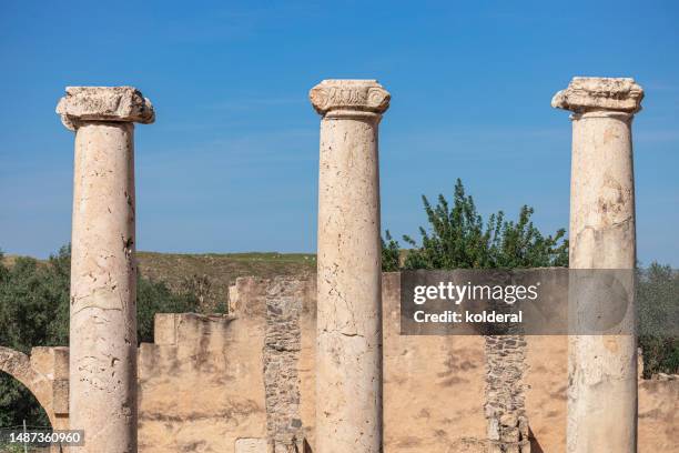 three ancient roman columns against blue sky - three objects stock pictures, royalty-free photos & images