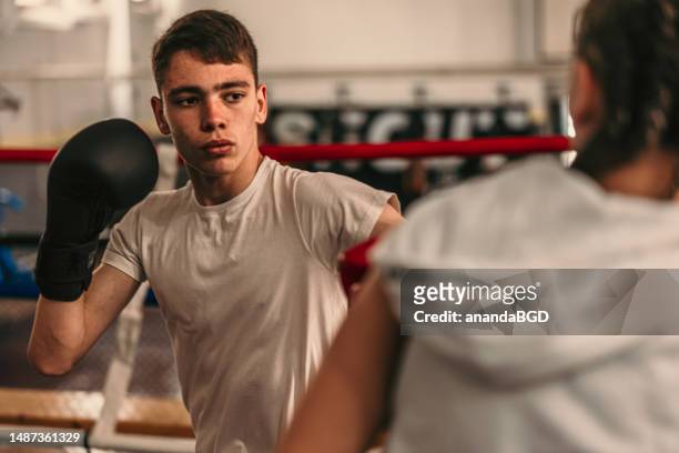 sparring and fighting on the boxing ring - boxing gym stock pictures, royalty-free photos & images