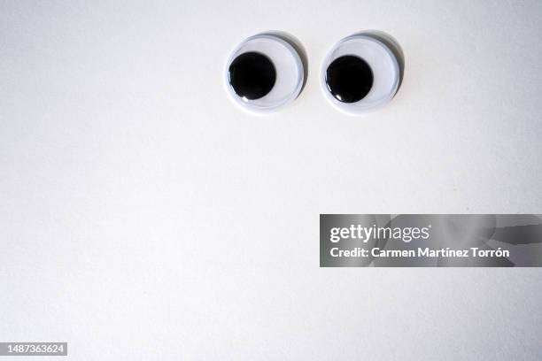 googly eyes on white. - cartoon eyes stock pictures, royalty-free photos & images