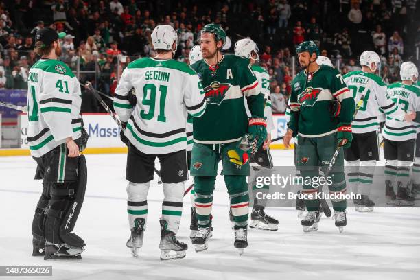 Marcus Foligno of the Minnesota Wild leads his team in shaking hands with the Dallas Stars after losing Game Six of the First Round of the 2023...