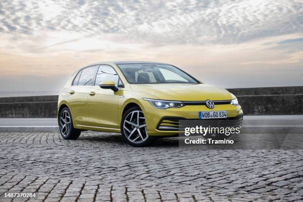 compact car - volkswagen golf on a parking - volkswagen stock pictures, royalty-free photos & images