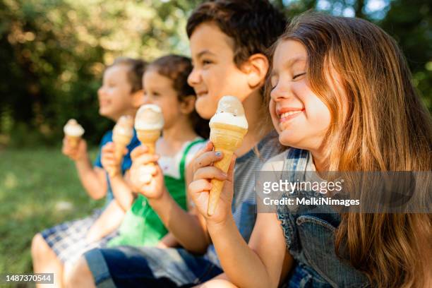 children eating ice cream in the summer - ice cream cone stockfoto's en -beelden