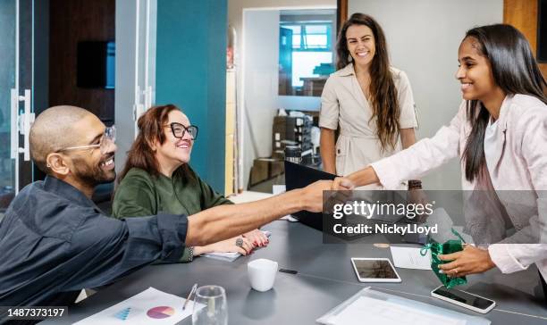 businessman appreciating a female colleague during meeting in office boardroom - werk in uitvoering stockfoto's en -beelden