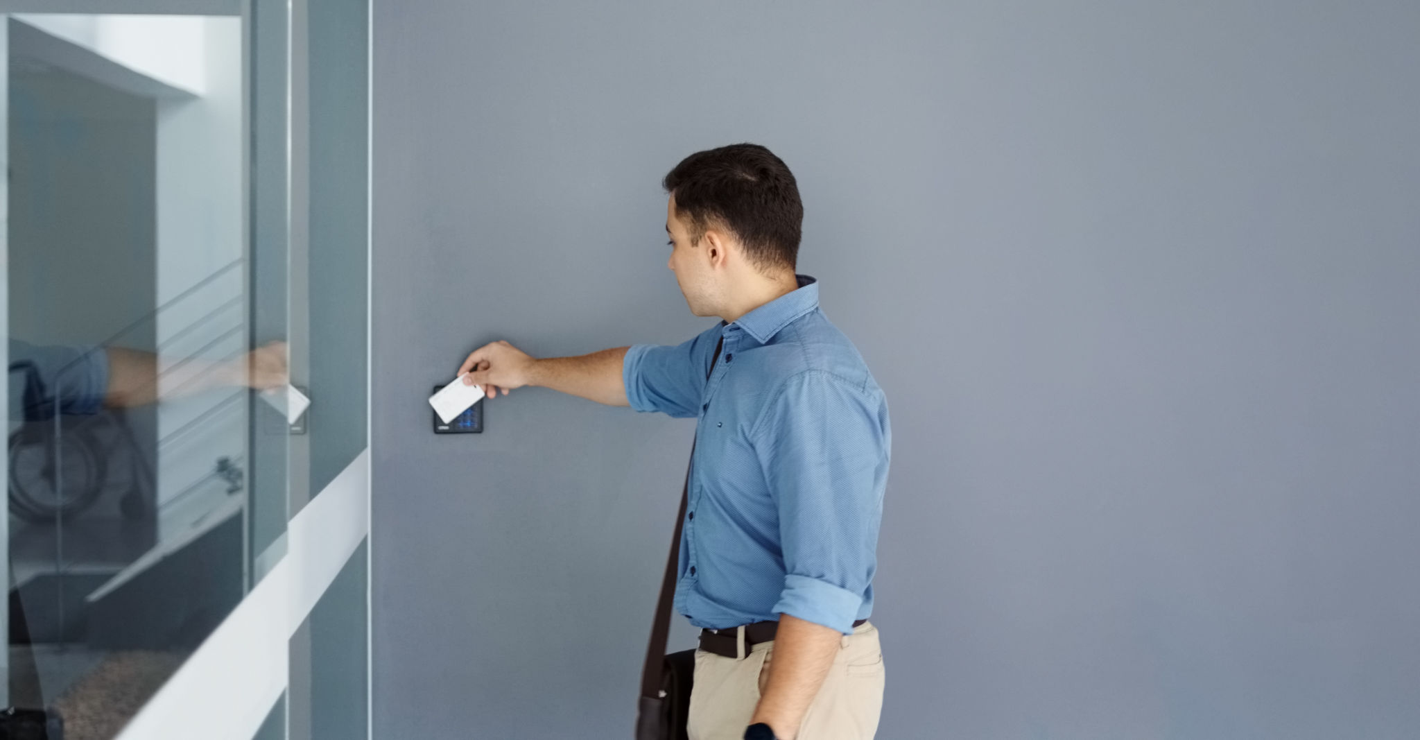 Young man using security key card to open office door Young man using security key card to open office door