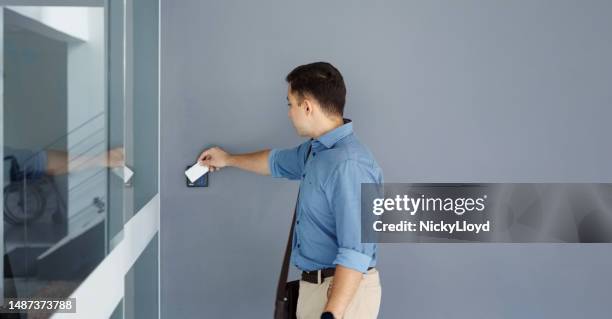 young man using security key card  to open office door - keycard access bildbanksfoton och bilder