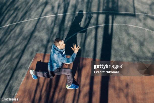 lunge exercise - man doing cross training. high-intensity interval training on the sports ground - buff headwear stock pictures, royalty-free photos & images