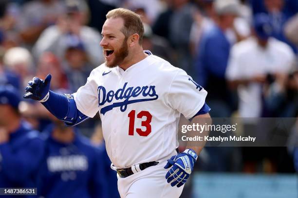 Max Muncy of the Los Angeles Dodgers celebrates his walk-off grand slam home run during the ninth inning against the Philadelphia Phillies at Dodger...