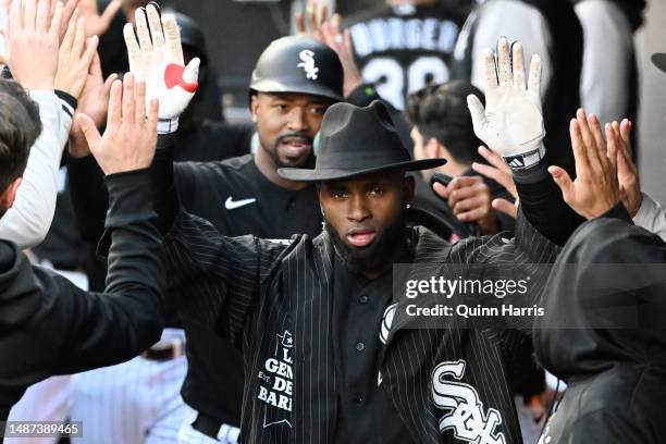 Luis Robert Jr. #88 of the Chicago White Sox celebrates in the dugout with teammates after his three run home run in the first inning against the...