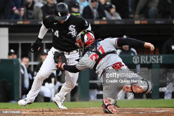 Yasmani Grandal of the Chicago White Sox is tagged out in the fourth inning against Ryan Jeffers of the Minnesota Twins at Guaranteed Rate Field on...