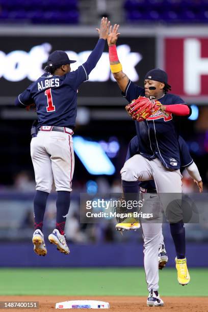 Ozzie Albies and Ronald Acuna Jr. #13 of the Atlanta Braves celebrate after defeating the Miami Marlins at loanDepot park on May 03, 2023 in Miami,...