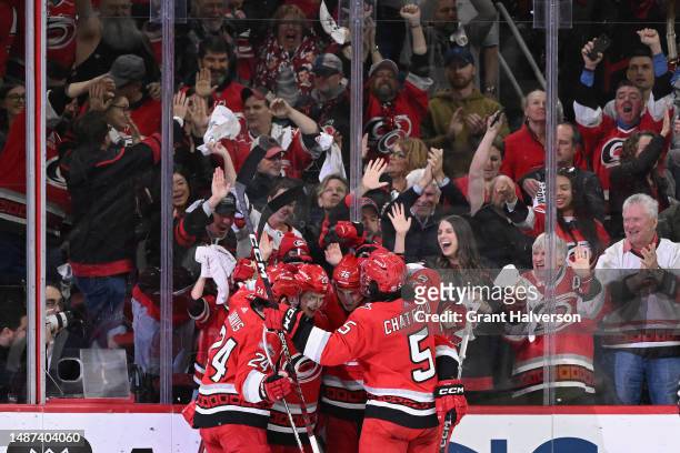 Brady Skjei of the Carolina Hurricanes celebrates with teammates after scoring a goal against the New Jersey Devils during the third period in Game...