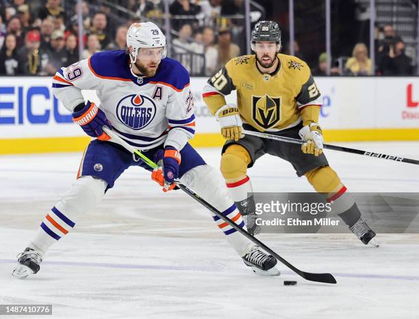 Leon Draisaitl of the Edmonton Oilers skates with the puck ahead of Chandler Stephenson of the Vegas Golden Knights in the first period of Game One...