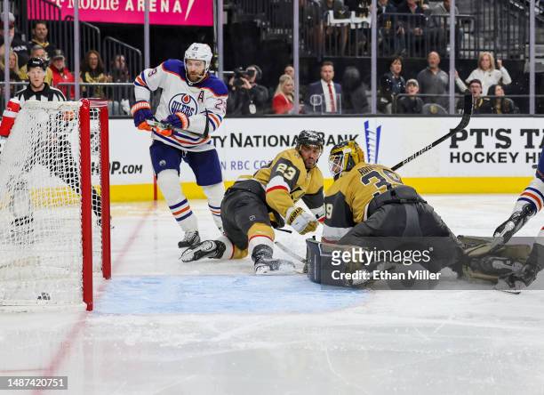 Leon Draisaitl of the Edmonton Oilers scores a third-period power-play goal, his third goal of the game, against Alec Martinez and Laurent Brossoit...