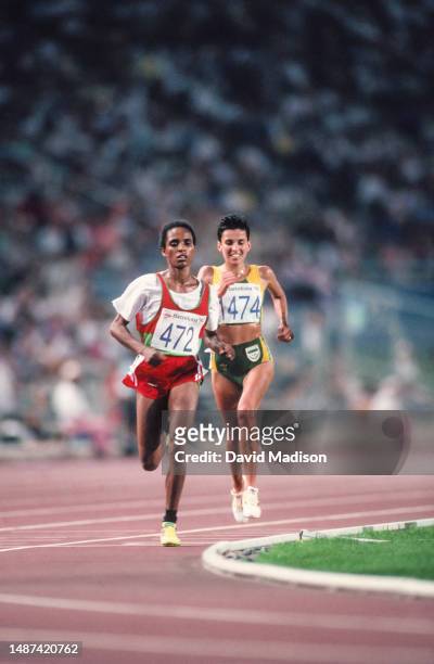 Derartu Tulu of Ethiopia followed by Elana Meyer of South Africa run in the Women's 10000 meters race of the Athletics competition at the 1992 Summer...