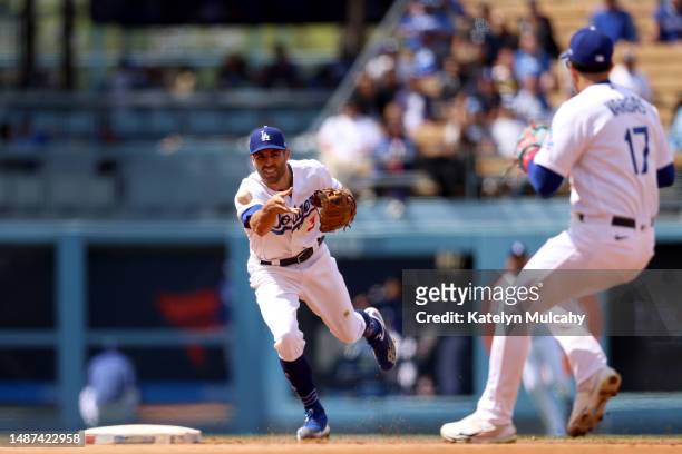Chris Taylor of the Los Angeles Dodgers tosses the ball to teammate Miguel Vargas for the out at second base during the seventh inning against the...