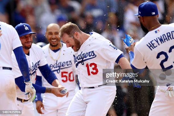 Max Muncy of the Los Angeles Dodgers celebrates his walk-off grand slam home run with teammates at home plate during the ninth inning against the...