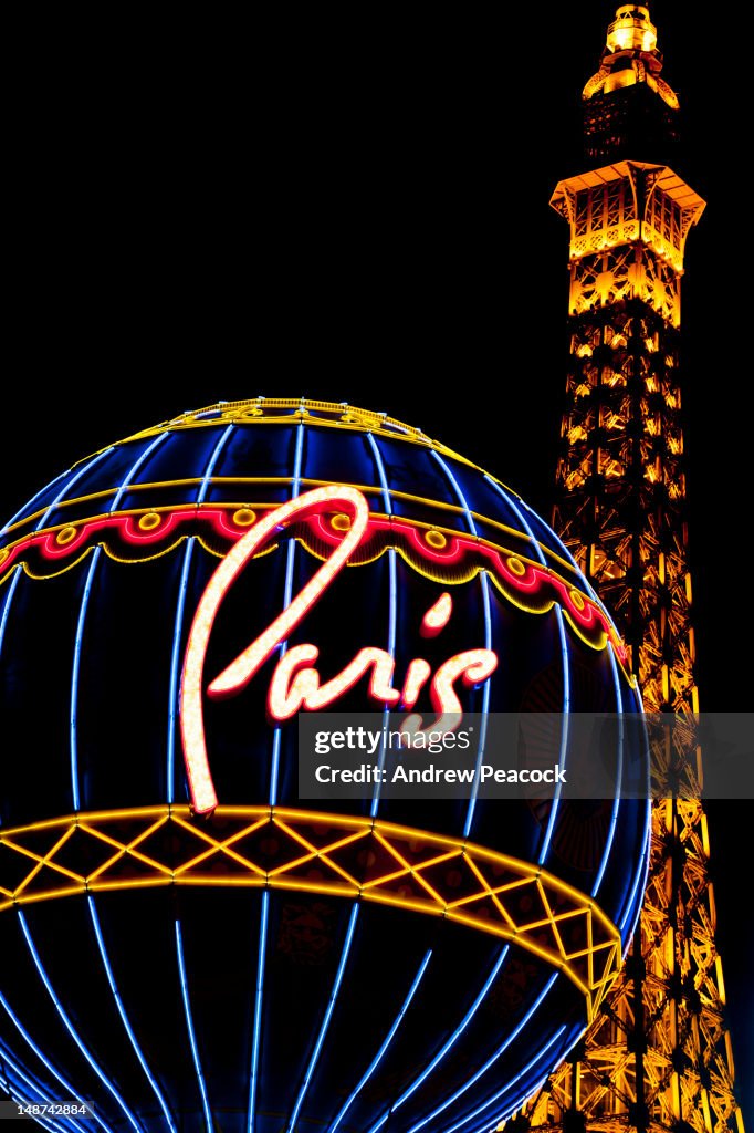 Neon sign and Eiffel Tower replica outside the Paris Las Vegas Hotel on 'The Strip'.