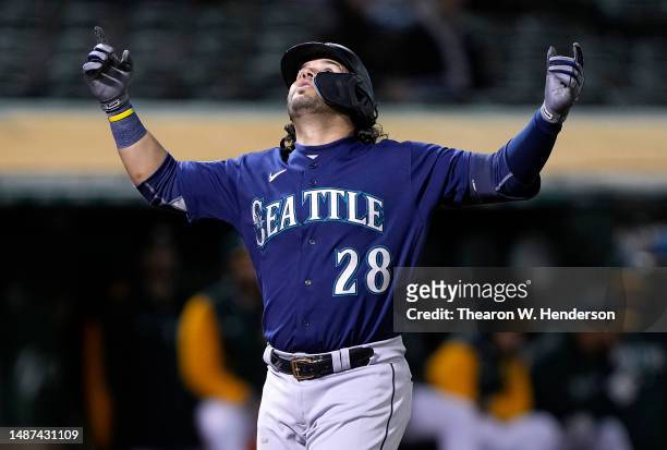 Eugenio Suarez of the Seattle Mariners celebrates after hitting a three-run home run against the Oakland Athletics in the top of the 10th inning at...