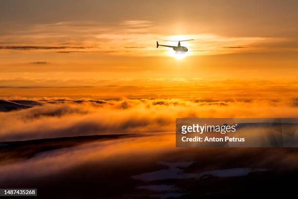helicopter on the background of the sunset sky - beach rescue aerial stockfoto's en -beelden