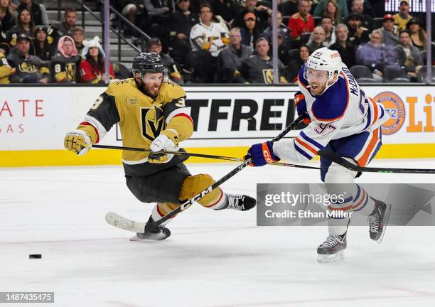 Connor McDavid of the Edmonton Oilers shoots against Brayden McNabb of the Vegas Golden Knights in the third period of Game One of the Second Round...