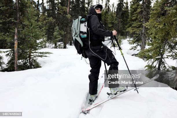 SnowEx researcher Dr. Kelly Gleason works on skis during field testing for snow albedo in a section of boreal forest during the melt season on May 3,...