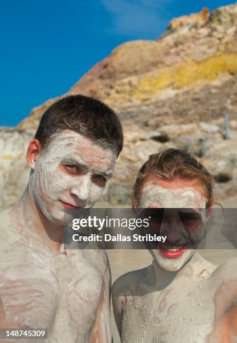 Mudcovered Young Couple Bathing At The Therapeutic Volcanic Thermal Mud mudcovered-young-couple-bathing-at-the-therapeutic-volcanic-thermal-mud