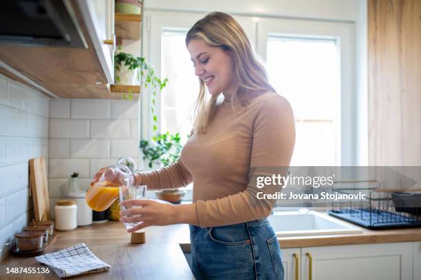 woman drinks fresh orange juice for good morning - juice box stock pictures, royalty-free photos & images