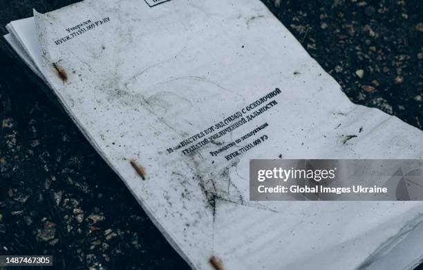 Russian instructions pamphlet on how to shoot from an under-barrel grenade launcher lies on the ground on April 1 in Kharkiv Oblast, Ukraine. The 209...