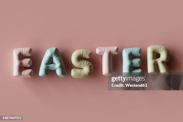 three dimensional render of inflatable letters spelling word easter - pastel coloured stock illustrations