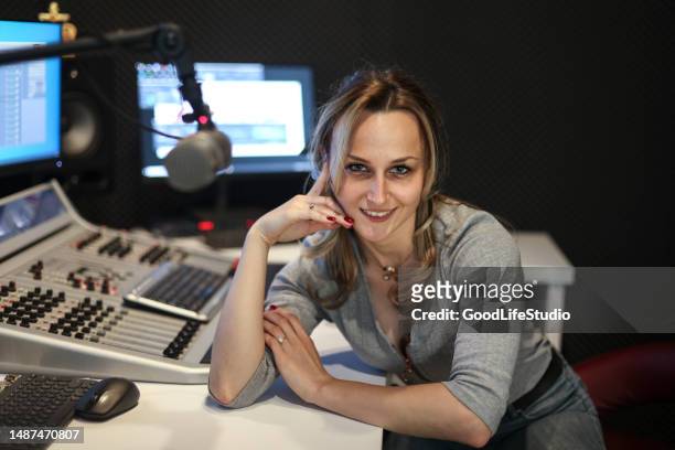 young woman working as a presenter at a radio station - radio dj stock pictures, royalty-free photos & images