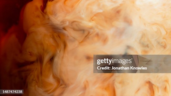 Close up cream cloud forming in coffee Close up cream cloud forming in coffee