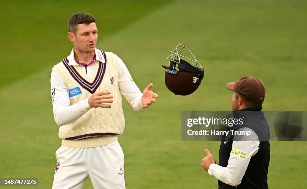 Cameron Bancroft of Somerset catches a helmet thrown to them by team mate Roelof van der Merwe during Day One of the LV= Insurance County...