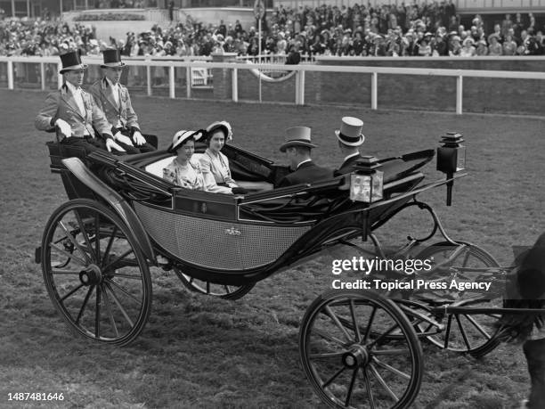 Princesses Elizabeth and Margaret driving down the course in procession on the third day of racing at Ascot, 16th June 1949.