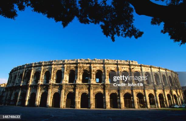 roman amphitheatres, known as arenas in nimes, were built around 100ad and seated 24,000 spectators and are the best preserved than any other in france - amphitheater stock pictures, royalty-free photos & images