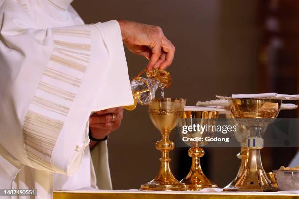 Catholic mass. Eucharist table with the liturgical items. Cruet with vine. France.