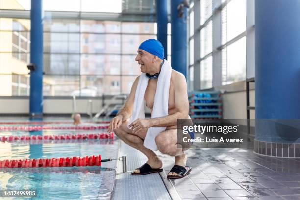 Pool Crounching Senior Man Swimmer With Towel Photos and Premium High Res Pictures ...