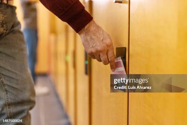 close-up of hand opening change room locker with keycard - keycard access stock pictures, royalty-free photos & images