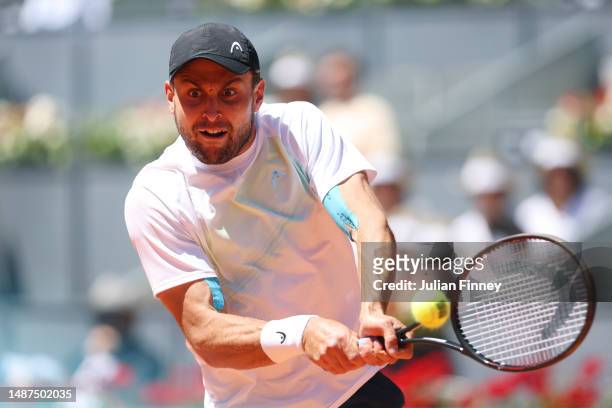 Aslan Karatsev plays a backhand against Zhizhen Zhang of People's Republic of China during the Men's Quarter Final match on Day Eleven of the Mutua...