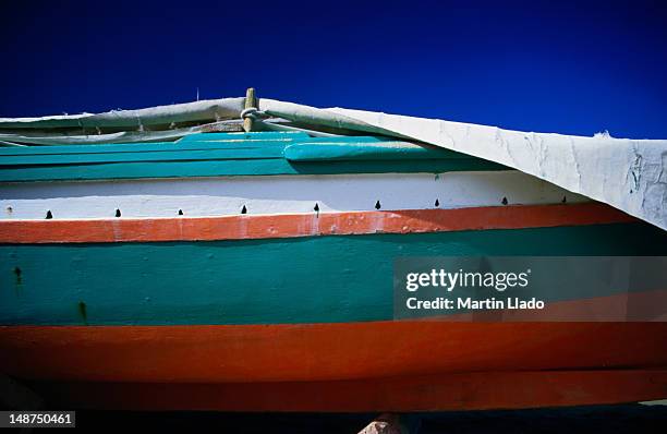 the painted hull of a fishing boat in giardini naxos. - giardini naxos stock pictures, royalty-free photos & images