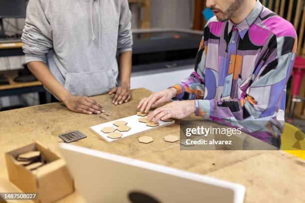 engineers working on laser wood cutting project at workshop - laser engraving stock pictures, royalty-free photos & images