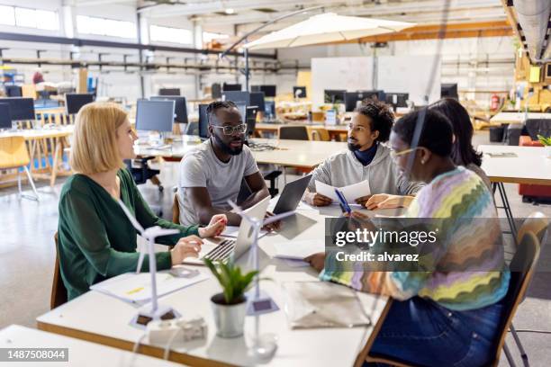 african businessman planning strategy with colleagues during a meeting - environment stock pictures, royalty-free photos & images